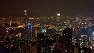 a view of a city at night from the top of a hill
