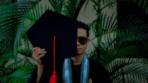 a man in sunglasses and a graduation cap