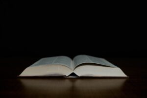 an open book sitting on top of a wooden table