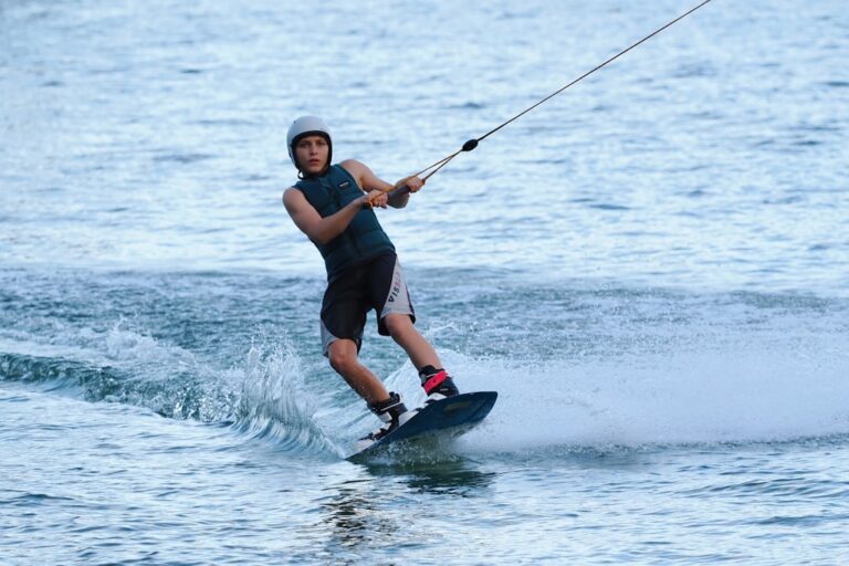 Young man wakeboarding on a calm lake