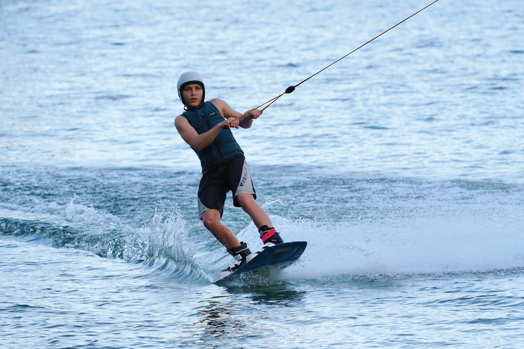 Young man wakeboarding on a calm lake