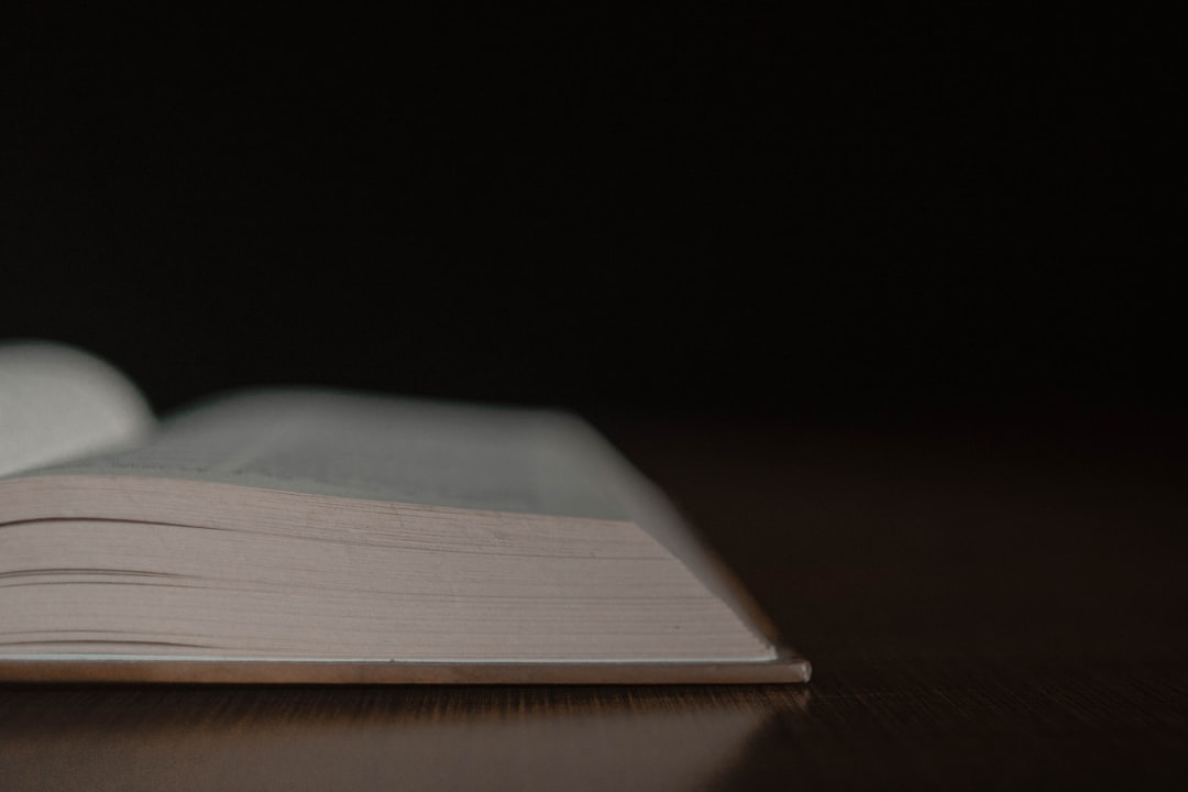 an open book sitting on top of a wooden table