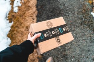 a person holding a box of food in their hand