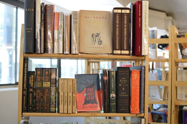 A wooden bookshelf filled with various old books.