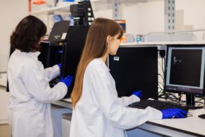 Two scientists working on computers in a laboratory.