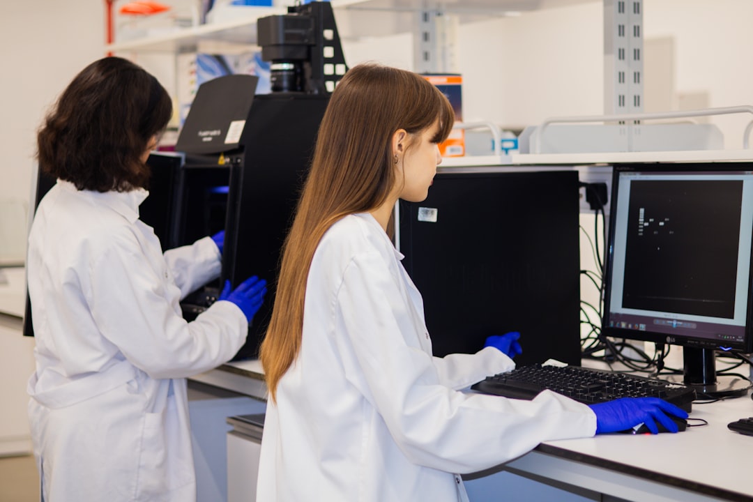 Two scientists working on computers in a laboratory.
