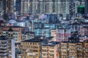a view of a city at night with lots of tall buildings