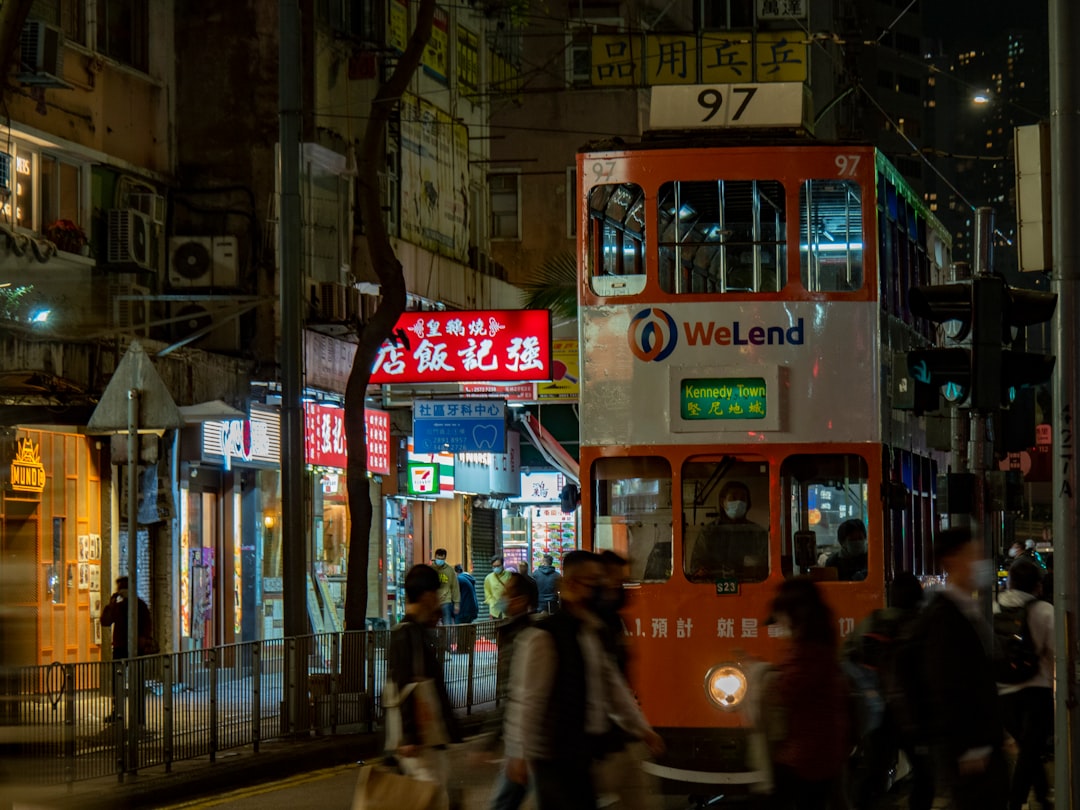 a double decker bus driving down a street at night
