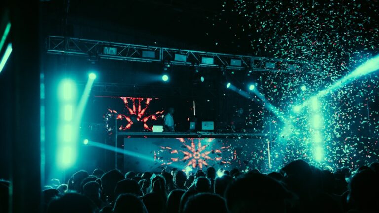 Dj performing for a crowd with confetti and lights