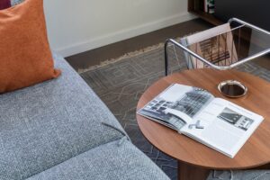 Modern living room with sofa, coffee table, and open book.