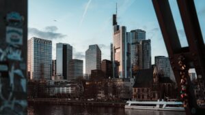 Modern skyscrapers rise above a city skyline at dusk.