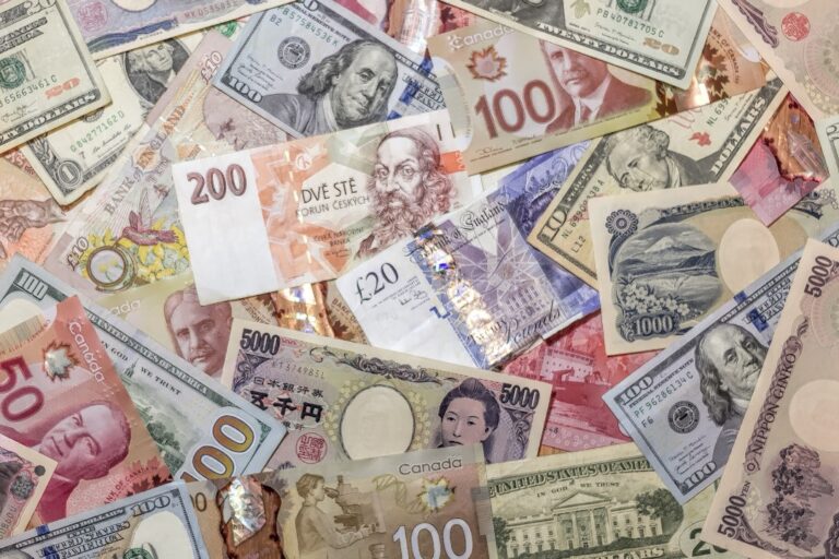 A chaotic pile of various international banknotes.