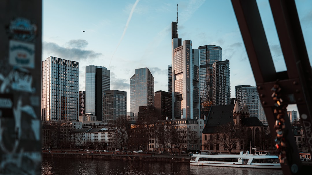 Modern skyscrapers rise above a city skyline at dusk.