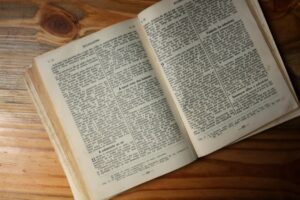 an open book sitting on top of a wooden table