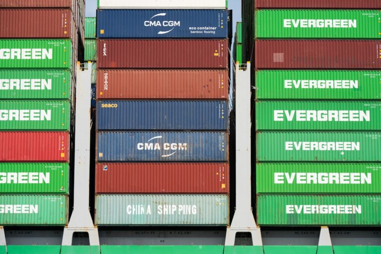 Stacked green, red, and blue shipping containers.