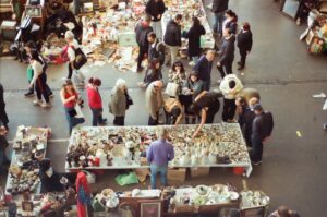 a crowd of people standing around a market