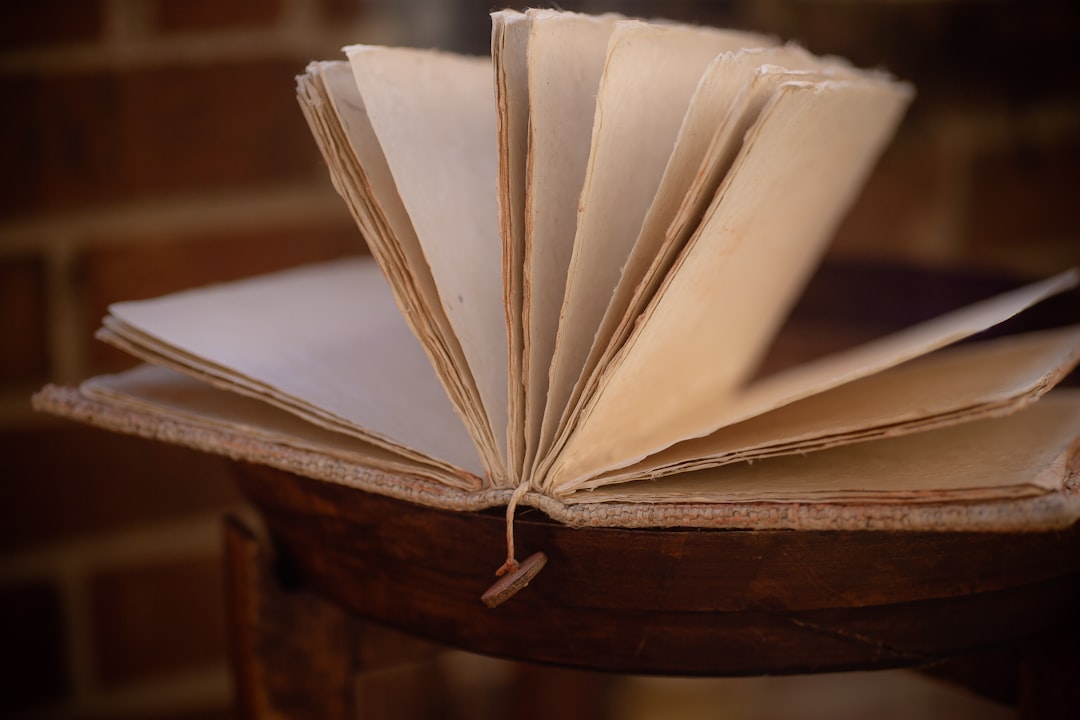 white book on brown wooden table