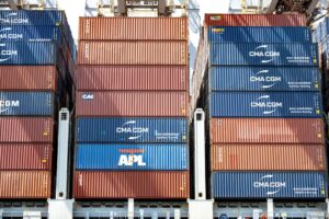 Stacked blue and red shipping containers on a cargo ship.