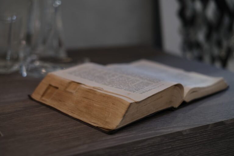 an open book sitting on top of a wooden table