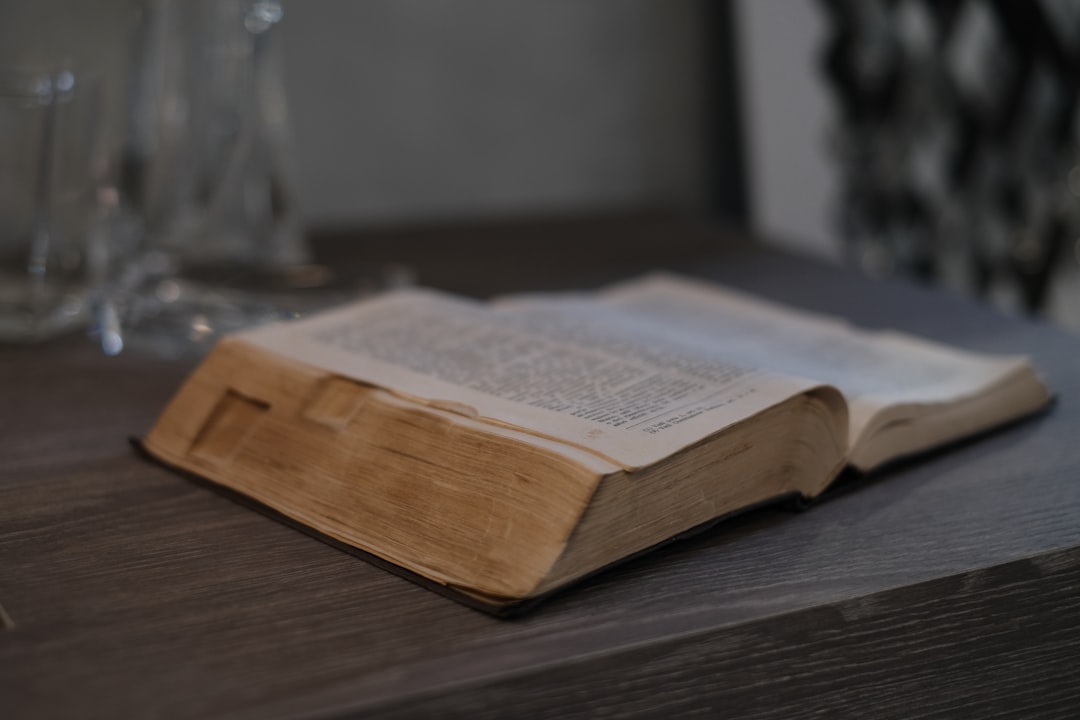 an open book sitting on top of a wooden table