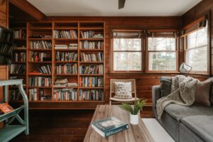 Cozy living room with large bookshelf and comfortable seating.