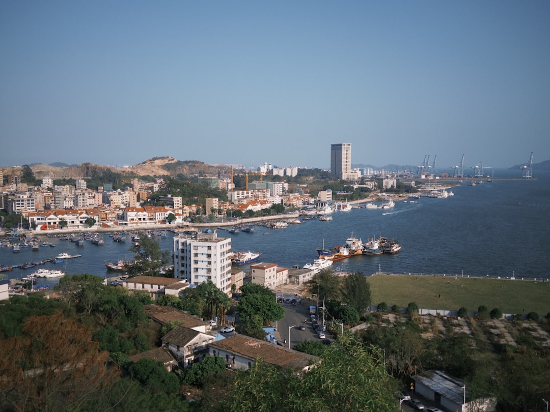 Coastal city with a harbor full of boats.