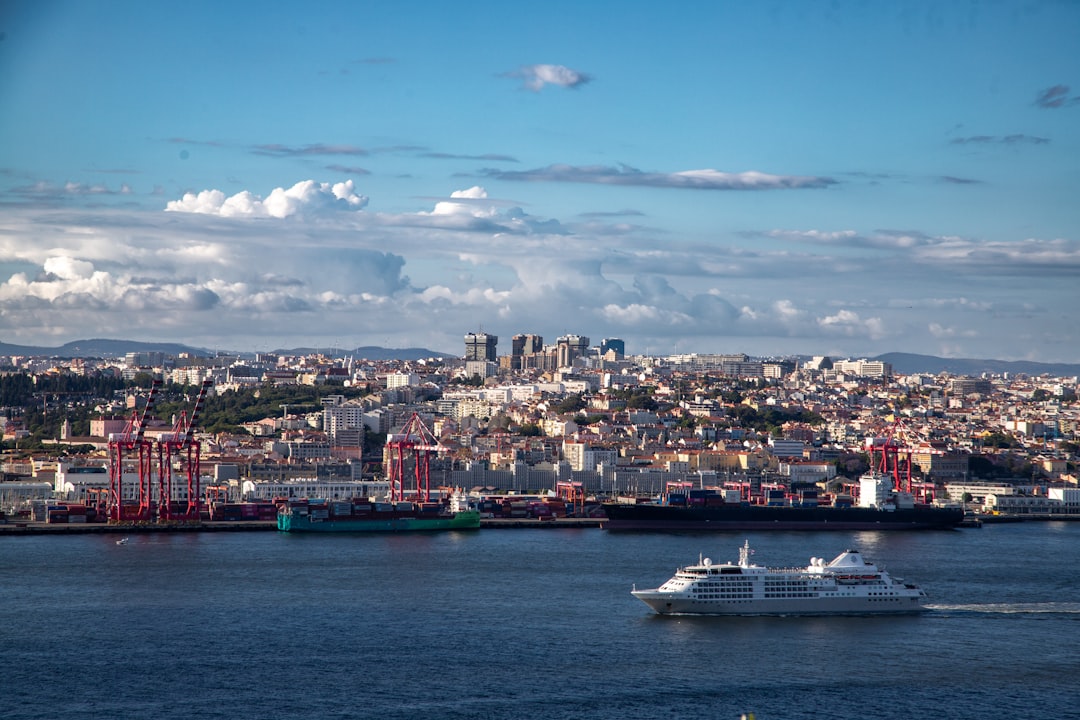 A city skyline overlooks a busy port with ships.