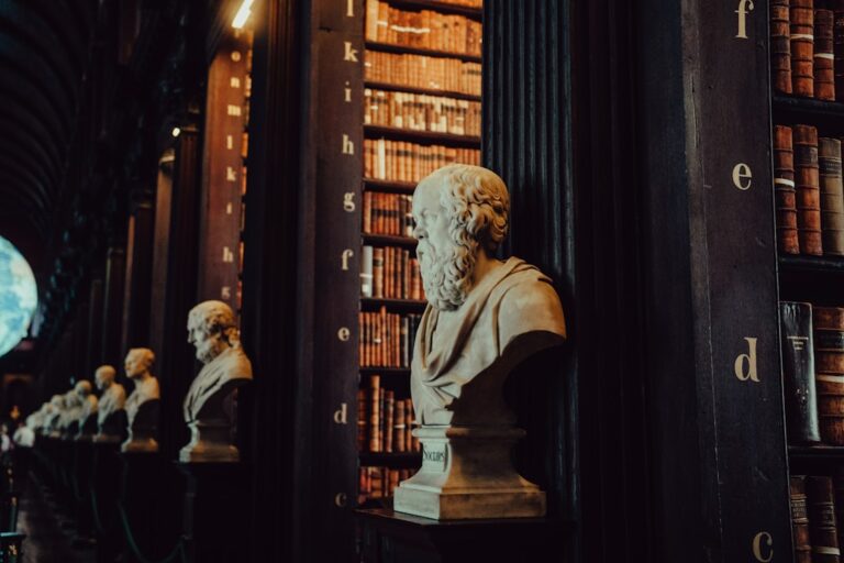 Busts and bookshelves in a grand library