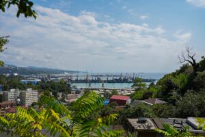Port city with cranes and ships on the water.