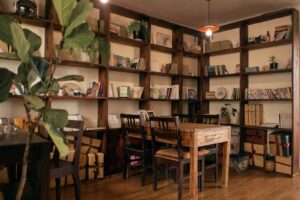 Cozy room with wooden shelves, books, and a table.