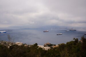 Ships at sea under a cloudy sky
