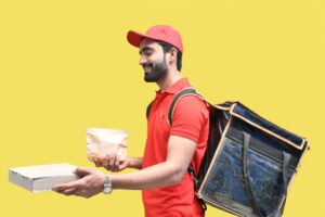 a man holding a book and a laptop