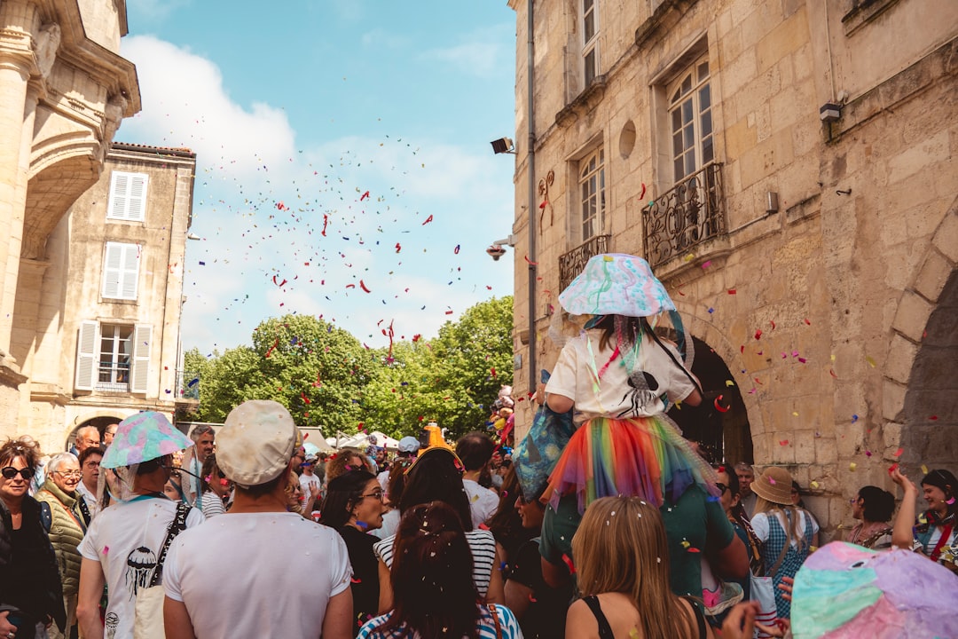 People celebrate with confetti during a street festival.