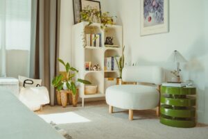 Bright, cozy room with plants and a white chair.